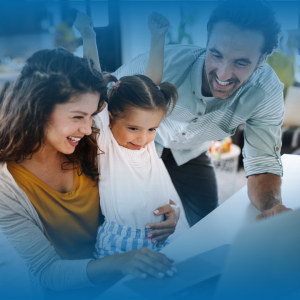 Happy family at computer, young daughter is cheering.